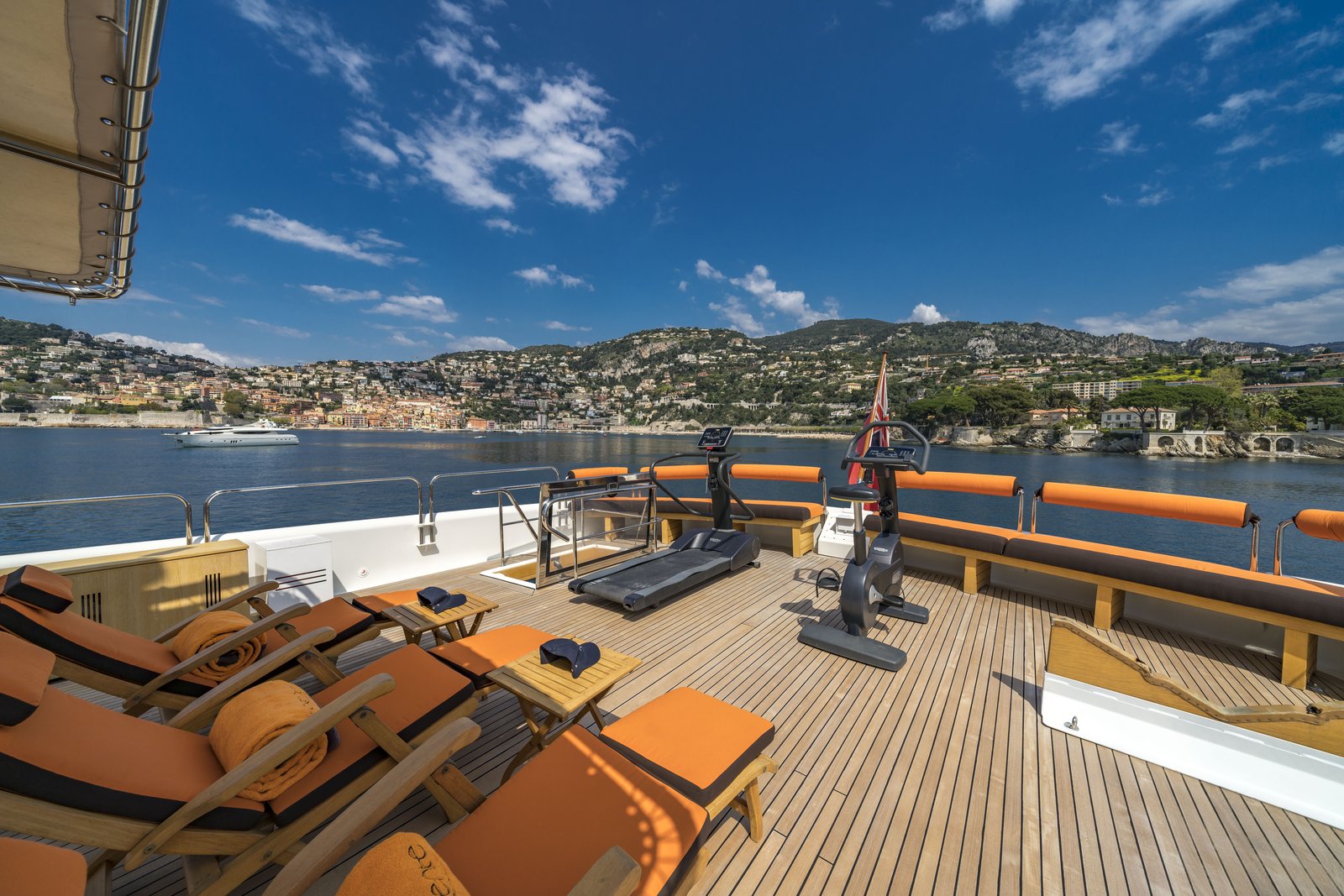 Aft deck table setting — napkin fold with Villefranche hills beyond