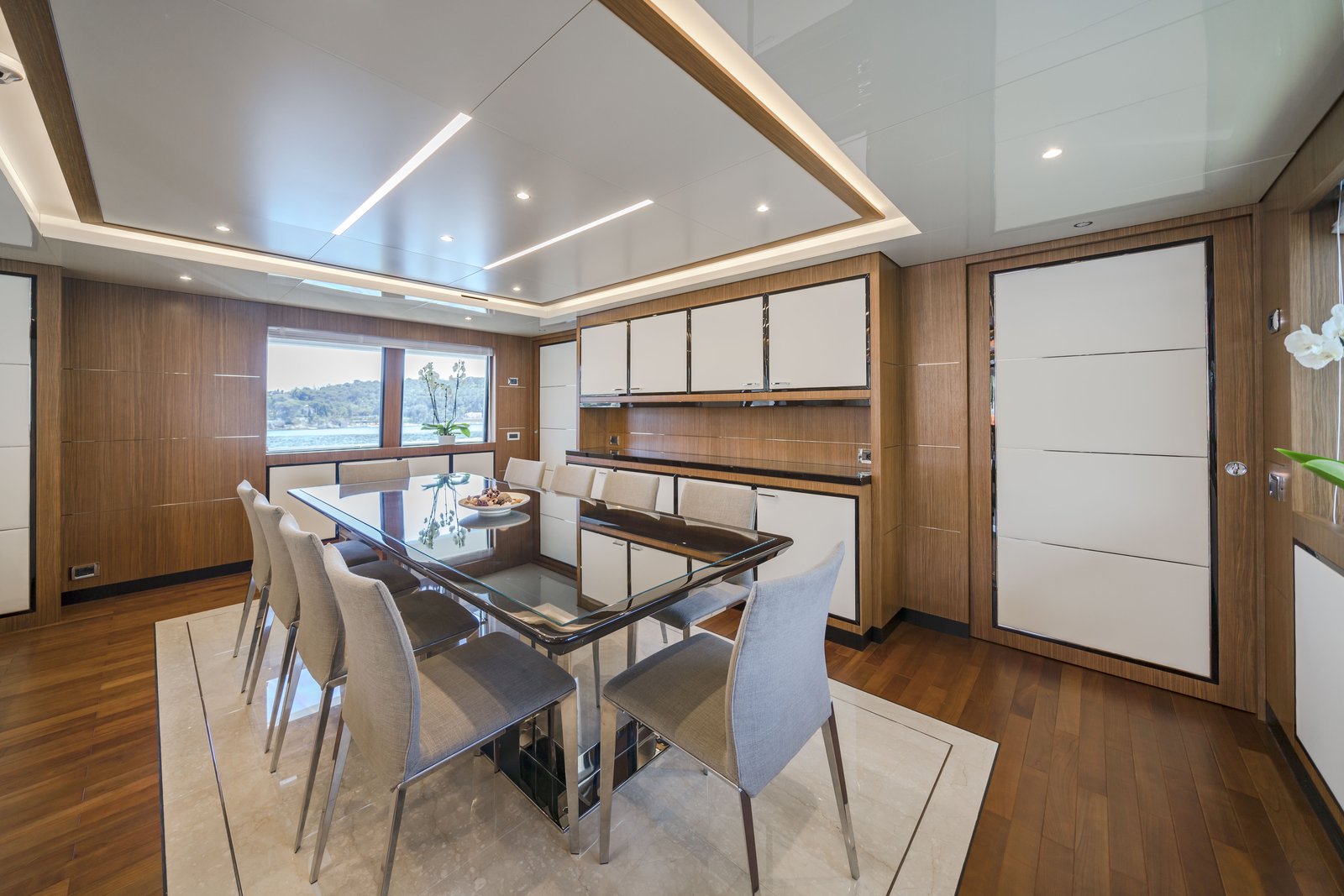 Formal dining salon — glass table with upholstered chairs