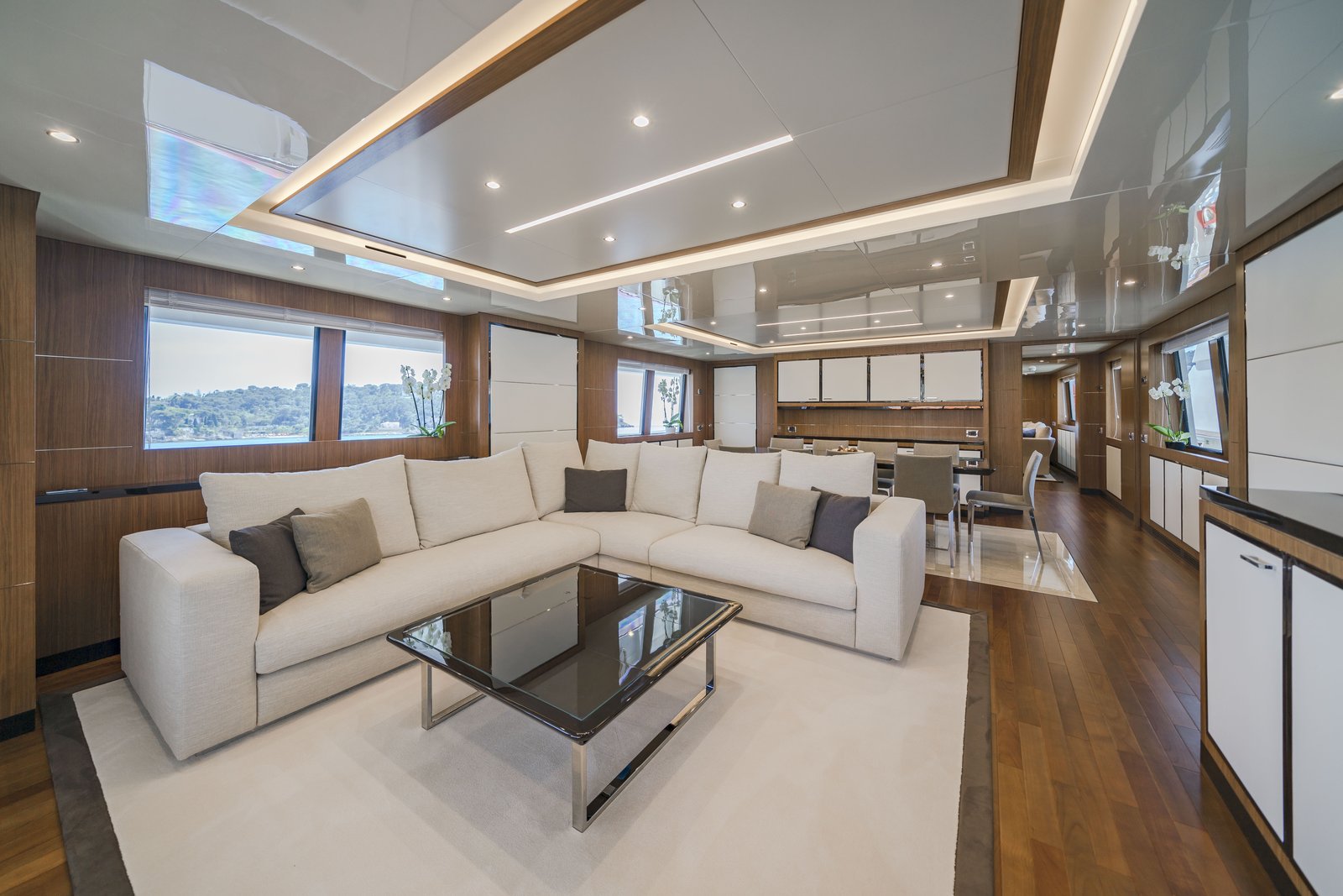 Main deck salon — cream L-sectional sofa with views over the Côte d'Azur