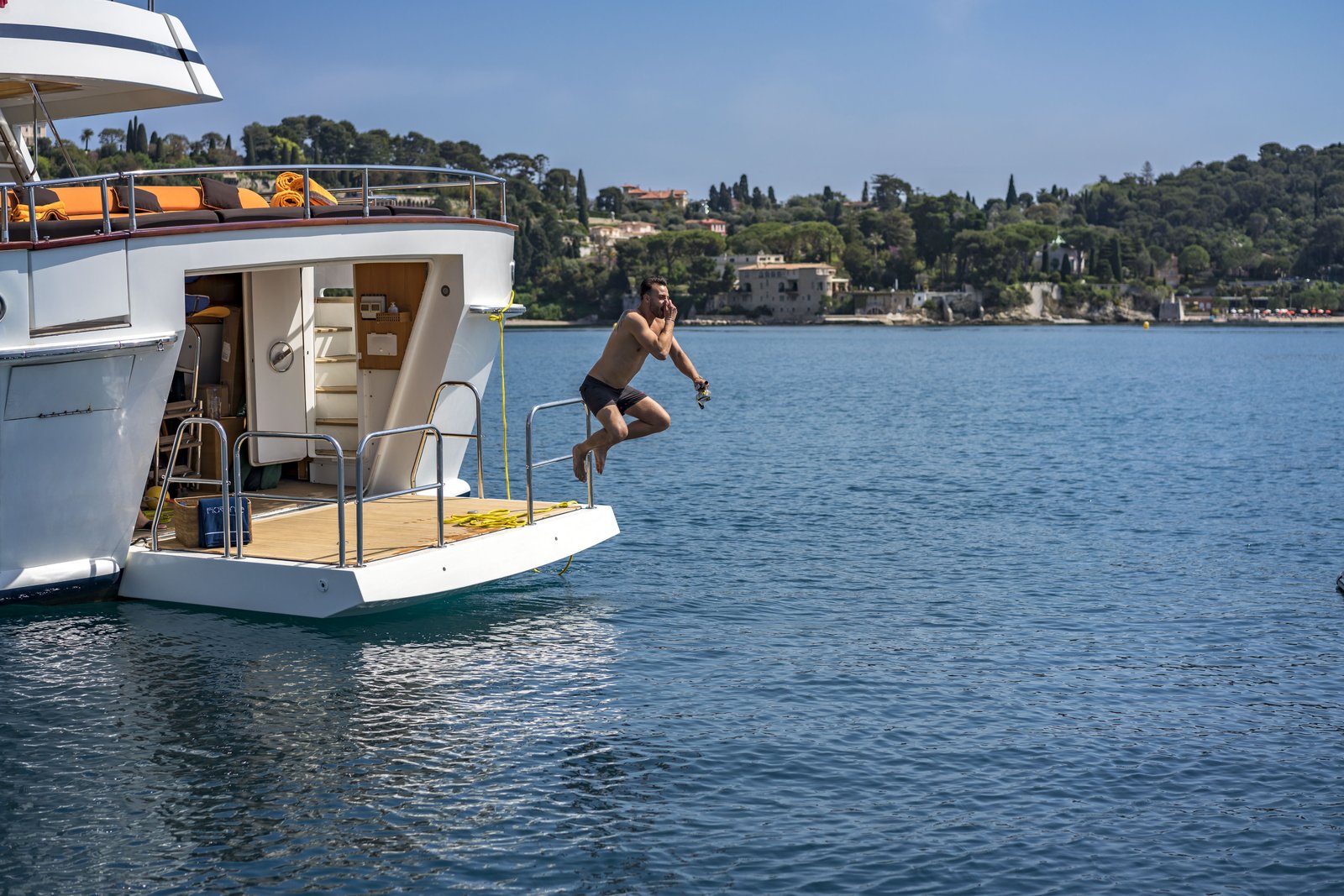 Guests paddleboarding and jet-skiing from Fiorente's swim platform
